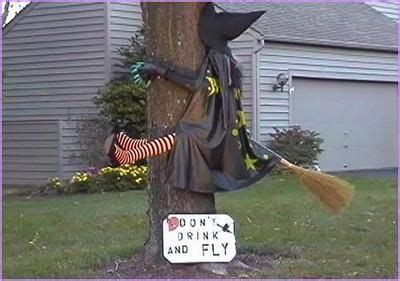 Witch sculpture hitting a halloween tree ornament